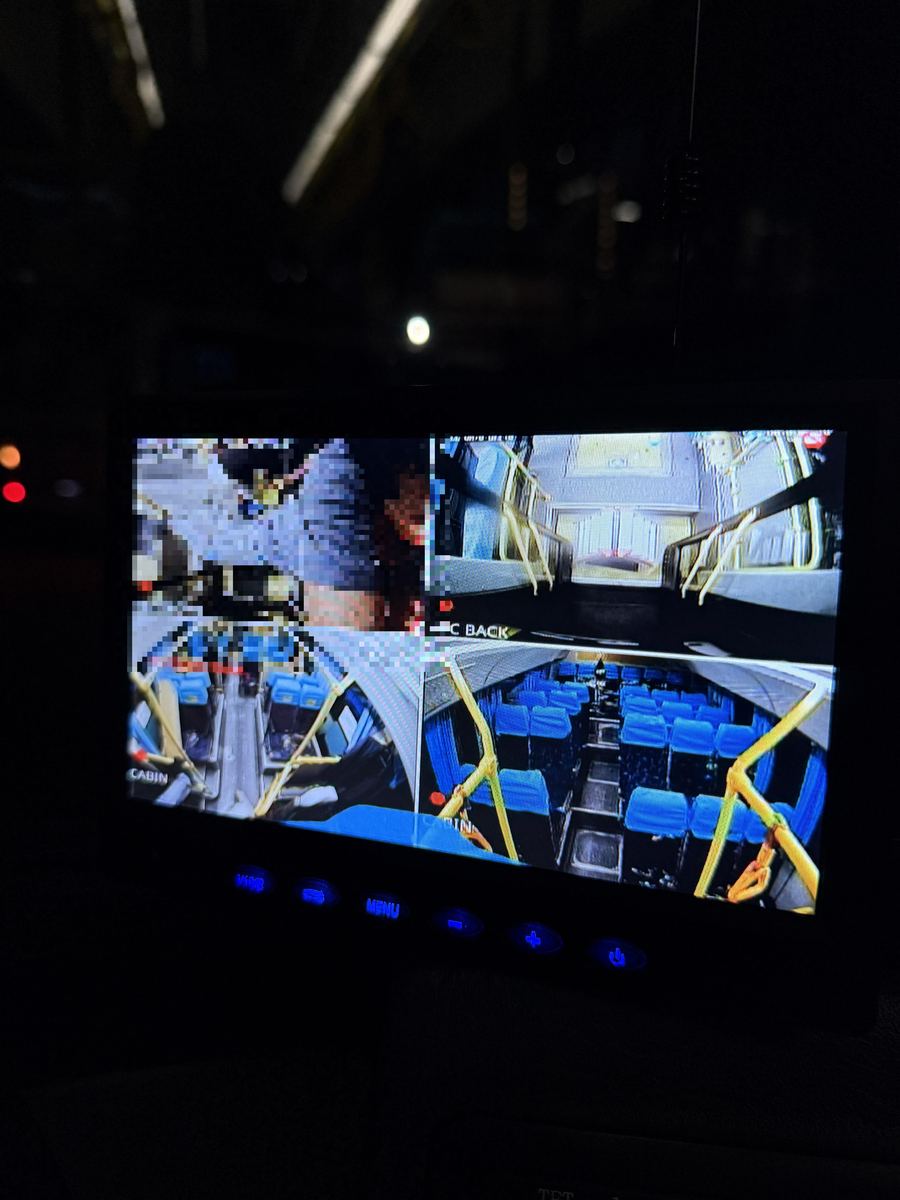 Live monitor showing four onboard camera feeds — front door, back door, and cabin views — used to verify the installation.