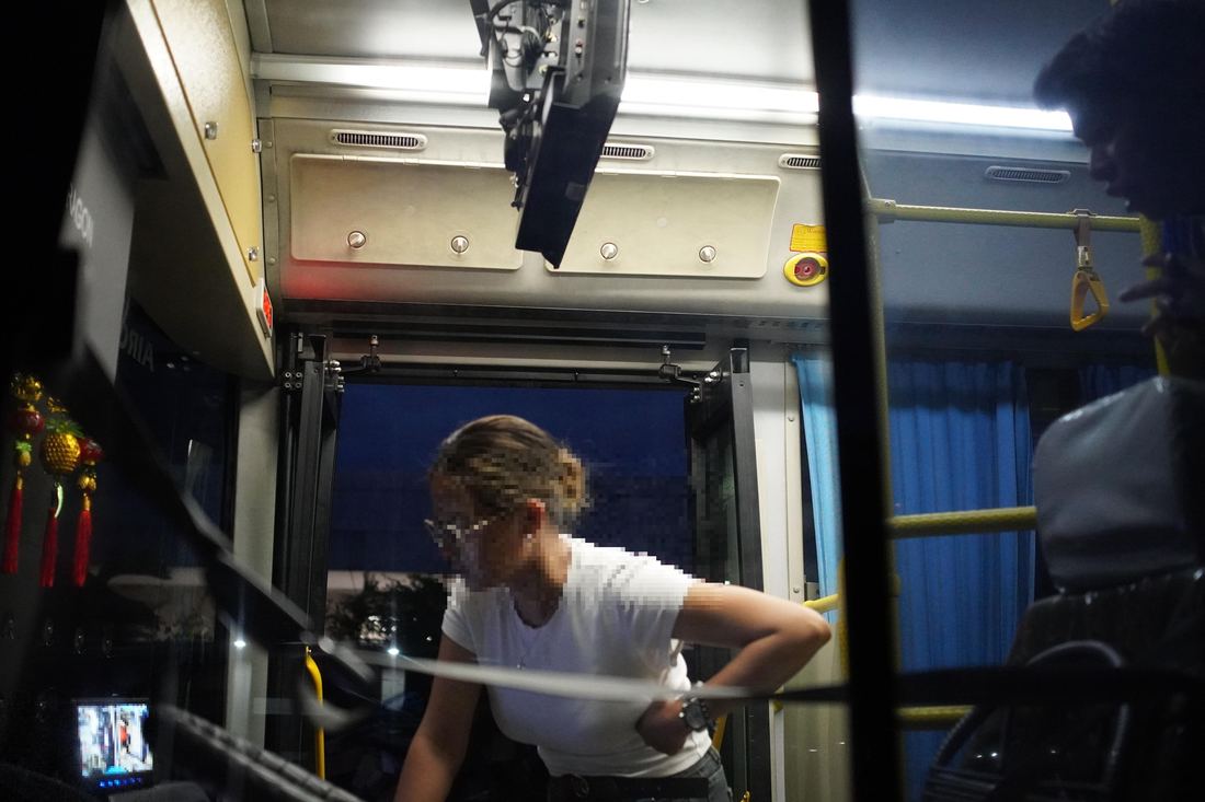 An InfraLinx engineer testing the system on a bus at night as part of field verification.